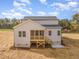 A full back view of a two-story house featuring a screened in porch at 57 Nottoway Ln, Wendell, NC 27591