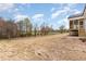 Open backyard of a new home construction, partially graded at 57 Nottoway Ln, Wendell, NC 27591