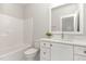 Bathroom with white vanity, modern sink, and combined bathtub and shower at 57 Nottoway Ln, Wendell, NC 27591