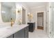 Dual vanity bathroom with marble floors, white countertops, and brass hardware at 57 Nottoway Ln, Wendell, NC 27591