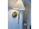 Bathroom sconce with brass finish and a classic lampshade design, mounted next to an open doorway at 57 Nottoway Ln, Wendell, NC 27591