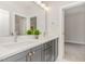 Bathroom with double sink vanity, modern fixtures, and gray cabinets with brushed brass hardware at 57 Nottoway Ln, Wendell, NC 27591