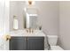 Charming bathroom features a gray vanity with a white countertop, gold faucet and mirror at 57 Nottoway Ln, Wendell, NC 27591