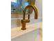 Close up on brass faucet, complemented by a matching framed mirror and bright white vanity top at 57 Nottoway Ln, Wendell, NC 27591
