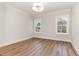 Bright bedroom with wood floors and natural light from two windows at 57 Nottoway Ln, Wendell, NC 27591
