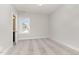 Bright bedroom with an open doorway leading into a bathroom, wood floors, and natural light from the window at 57 Nottoway Ln, Wendell, NC 27591