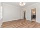 Spacious bedroom with wood floors and an open doorway leading into the bathroom at 57 Nottoway Ln, Wendell, NC 27591