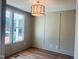 Dining room featuring hardwood floors, decorative trim, and a stylish chandelier at 57 Nottoway Ln, Wendell, NC 27591