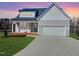 Charming two-story home with a well-manicured lawn and a two-car garage at 57 Nottoway Ln, Wendell, NC 27591