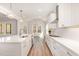 Bright kitchen featuring a large island, white cabinetry, quartz counters, and stainless steel appliances at 57 Nottoway Ln, Wendell, NC 27591