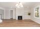 Spacious living room with a fireplace, built-in bookshelves, and natural light at 57 Nottoway Ln, Wendell, NC 27591