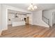 Open-concept living room featuring hardwood floors, fireplace, and seamless access to the kitchen at 57 Nottoway Ln, Wendell, NC 27591