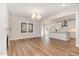 Open-concept living room featuring hardwood floors, fireplace, and seamless access to the kitchen at 57 Nottoway Ln, Wendell, NC 27591