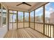 Enclosed porch with wood flooring and an expansive outdoor view. Ceiling fan included at 57 Nottoway Ln, Wendell, NC 27591