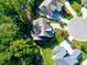 Aerial view of a house nestled amongst lush green trees and landscaping at 5904 Bellona Ln, Raleigh, NC 27612