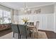 Formal dining room with wainscoting, chandelier, and hardwood floors at 5904 Bellona Ln, Raleigh, NC 27612