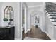 Bright foyer with hardwood floors, powder room and staircase at 5904 Bellona Ln, Raleigh, NC 27612