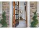 Elegant front door entrance with glass panels opening to a hardwood foyer at 5904 Bellona Ln, Raleigh, NC 27612