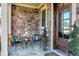 Inviting front porch with stonework and comfortable seating area at 5904 Bellona Ln, Raleigh, NC 27612
