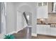 White kitchen features stainless steel appliances and an island with seating at 5904 Bellona Ln, Raleigh, NC 27612