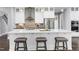 Bright kitchen with white cabinets, center island, and stainless steel appliances at 5904 Bellona Ln, Raleigh, NC 27612