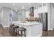 Modern kitchen with large island, stainless steel appliances, and white cabinetry at 5904 Bellona Ln, Raleigh, NC 27612
