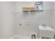 Bright laundry room with utility sink and shelving at 5904 Bellona Ln, Raleigh, NC 27612