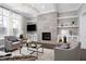 Spacious living room featuring a modern fireplace and built-in shelving at 5904 Bellona Ln, Raleigh, NC 27612