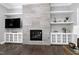 Living room with a large fireplace and built-in storage at 5904 Bellona Ln, Raleigh, NC 27612