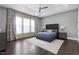 Spacious main bedroom with dark hardwood floors and large windows at 5904 Bellona Ln, Raleigh, NC 27612