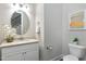 Small powder room with granite vanity and toilet at 5904 Bellona Ln, Raleigh, NC 27612