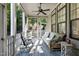 Relaxing screened porch with wicker furniture and ceiling fan at 5904 Bellona Ln, Raleigh, NC 27612
