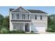 Two story house with gray siding, stone accents, and a two car garage at 605 Morning Light Dr, Angier, NC 27501