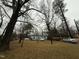 House nestled among trees with spacious yard and parked cars at 6908 Park Pl, Raleigh, NC 27616
