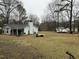 Large backyard with additional space, trees, and parked vehicles at 6908 Park Pl, Raleigh, NC 27616