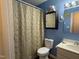 Bathroom with shower/tub combo, vanity, and beige shower curtain at 6908 Park Pl, Raleigh, NC 27616