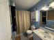 Bathroom with shower/tub combo, vanity, and beige shower curtain at 6908 Park Pl, Raleigh, NC 27616