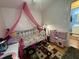 bedroom with daybed, play kitchen, and bathroom access at 6908 Park Pl, Raleigh, NC 27616