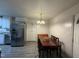 Bright dining area with wood table and chairs, adjacent to kitchen at 6908 Park Pl, Raleigh, NC 27616