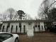 White ranch house with steps, landscaping, and parked cars at 6908 Park Pl, Raleigh, NC 27616