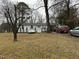 White house with yard, showcasing curb appeal and ample parking at 6908 Park Pl, Raleigh, NC 27616
