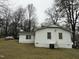 Another side view of the house, showing a large yard and AC unit at 6908 Park Pl, Raleigh, NC 27616