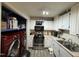 Galley kitchen with stainless steel appliances and laundry closet at 6908 Park Pl, Raleigh, NC 27616