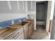 Bathroom featuring unfinished vanity with drawers, wood accents, and tile floors at 7934 Wexford Waters Ln, Wake Forest, NC 27587