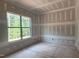 Unfinished bedroom featuring a large window that offers natural light and views of the outdoors at 7934 Wexford Waters Ln, Wake Forest, NC 27587