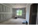 Bright bedroom with large window, drywall construction, and natural light at 7934 Wexford Waters Ln, Wake Forest, NC 27587