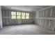 Unfinished bedroom showcasing a large window, natural light, and neutral wall color at 7934 Wexford Waters Ln, Wake Forest, NC 27587