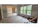 Bright bedroom featuring a sliding door to the outdoors and a large window showcasing natural light at 7934 Wexford Waters Ln, Wake Forest, NC 27587
