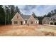 New construction single-Gathering home featuring a brick facade and symmetrical gabled roofline at 7934 Wexford Waters Ln, Wake Forest, NC 27587