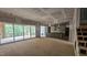 Spacious room showcasing sliding glass doors to a deck and a kitchen view at 7934 Wexford Waters Ln, Wake Forest, NC 27587